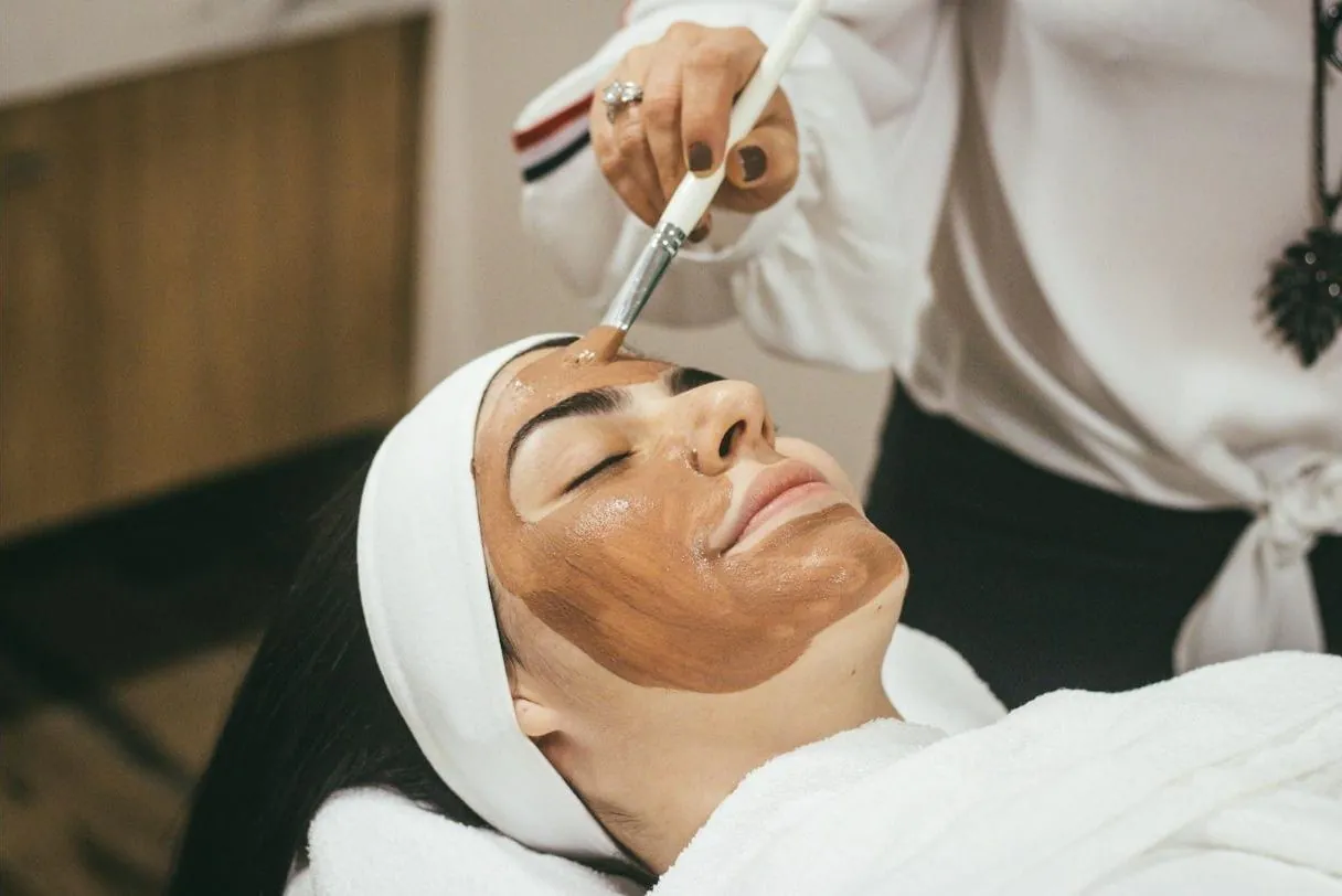 Esthetician applying a facial mask at RJ Aesthetics in Old Bridge, NJ